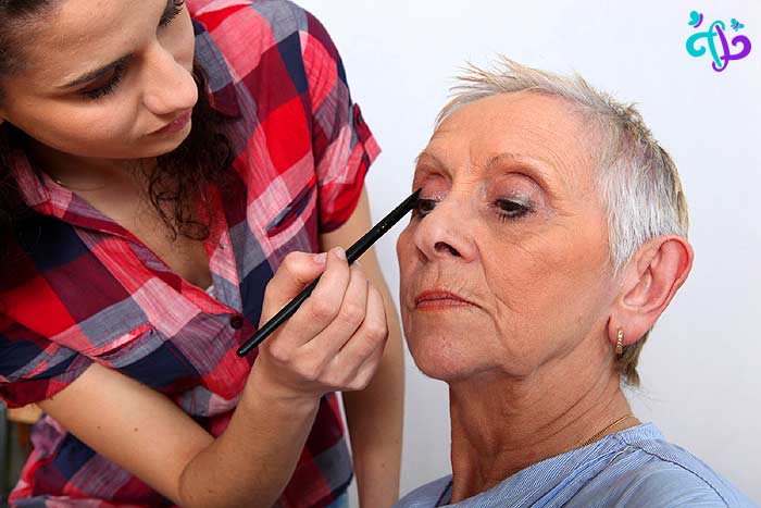 Applying makeup for older woman